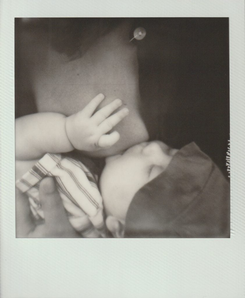 Polaroid film of a mother breastfeeding her newborn baby