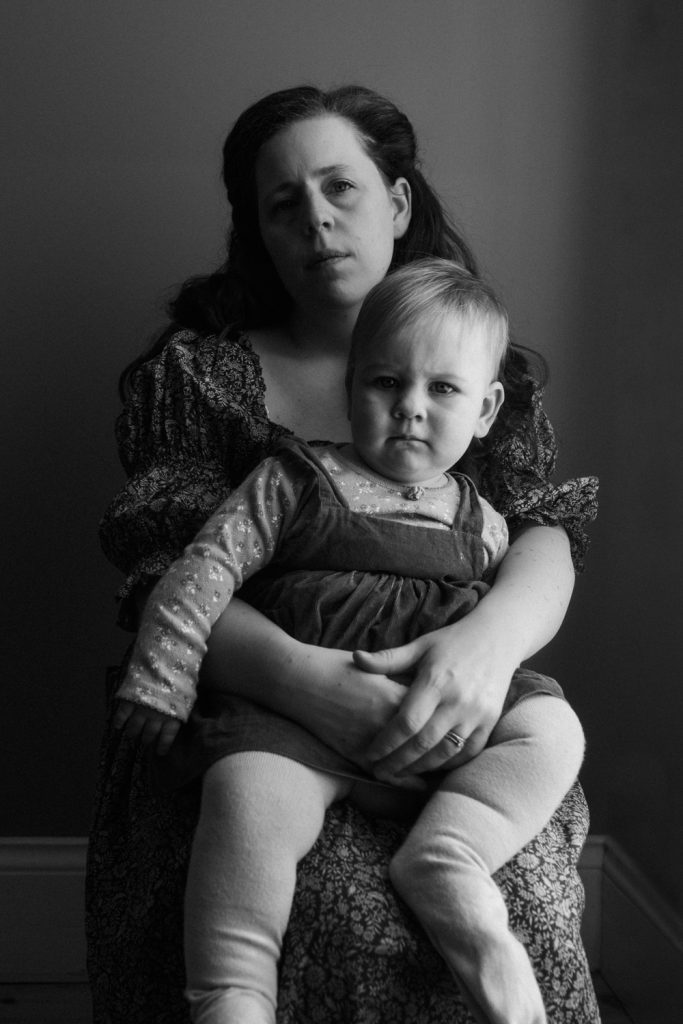 An intimate black and white portrait of the photographer, Hanna Wolf and her daughter.